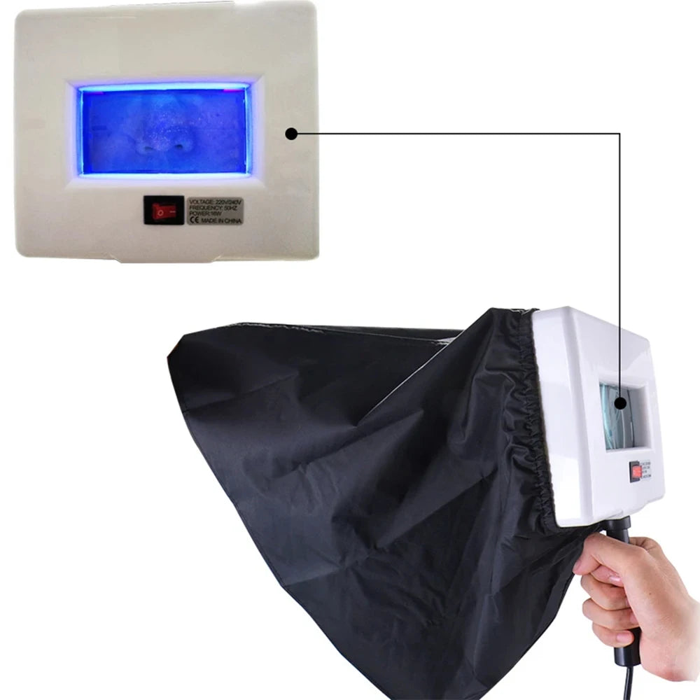Hair removal device with screen and black cover, held by a hand.