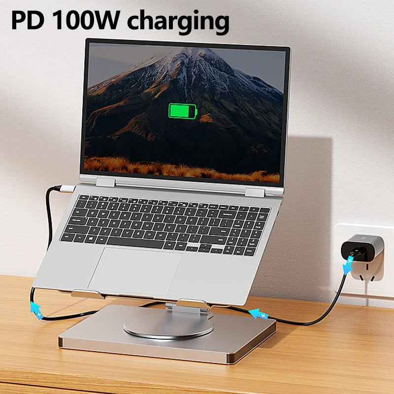 Laptop on a stand with charging cable and power adapter, displaying 'PD 100W charging' text.