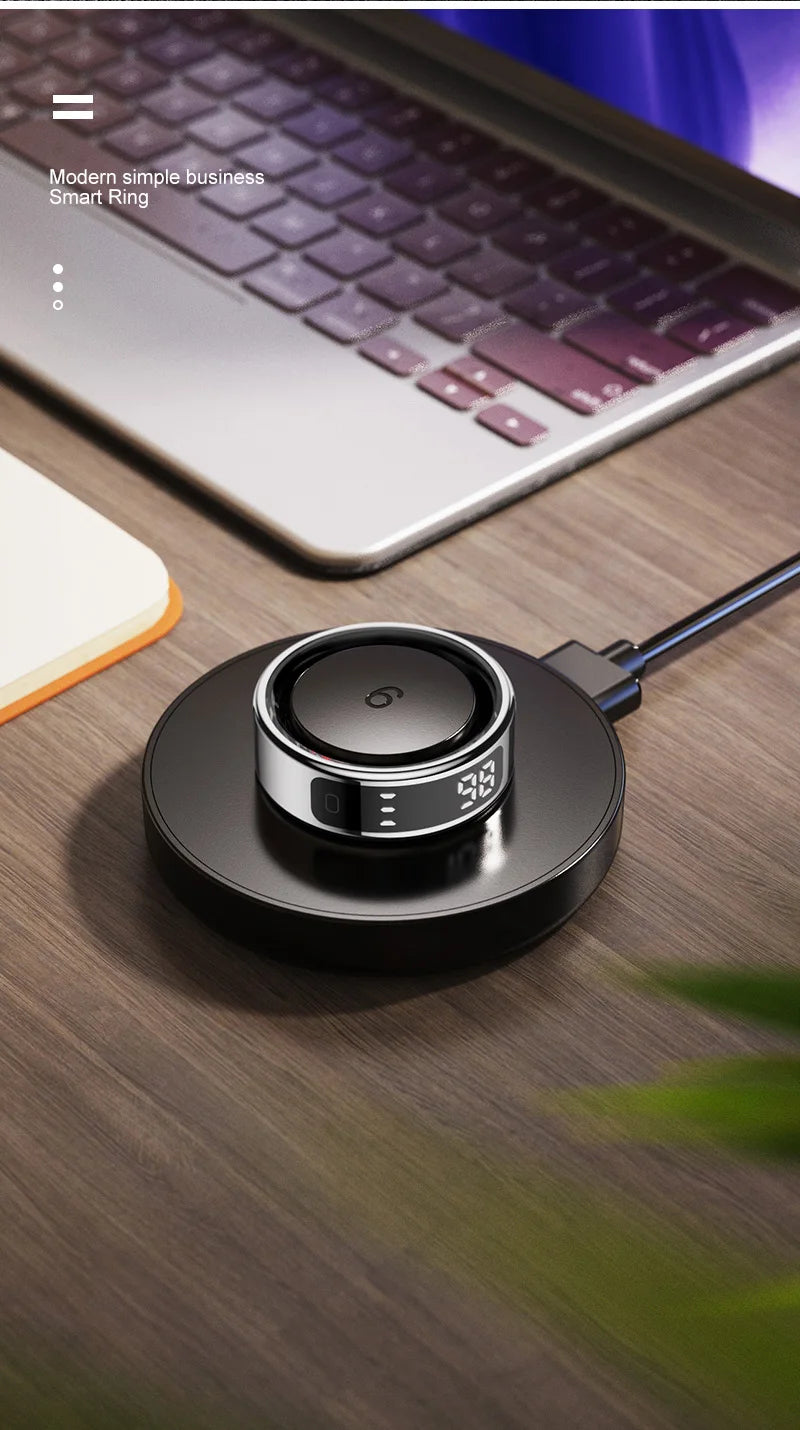 Black wireless charging pad on a wooden surface with a laptop in the background