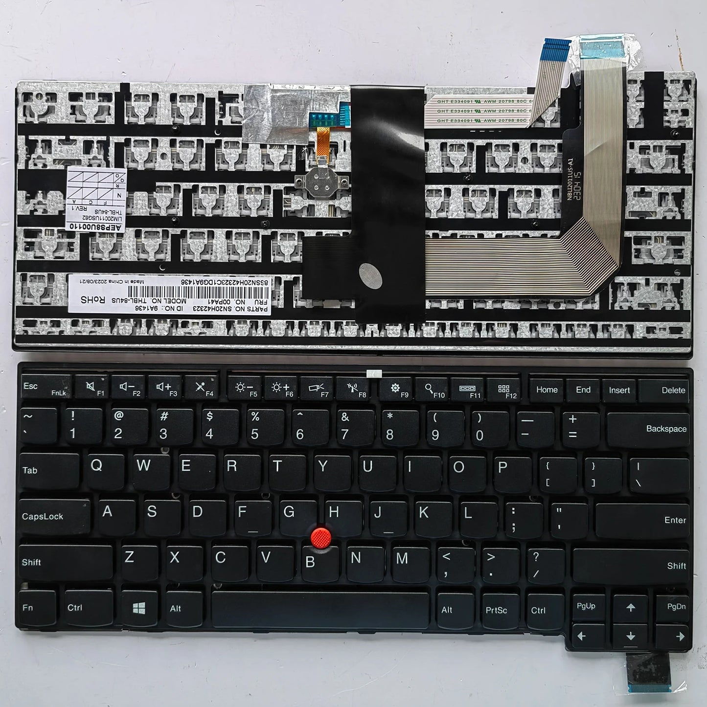 Close-up of a laptop keyboard with visible circuitry on a white background